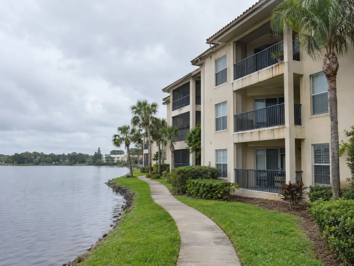 Mold remediation in Altamonte Springs, FL · illustrative image of lakeside condos with stained stucco balconies